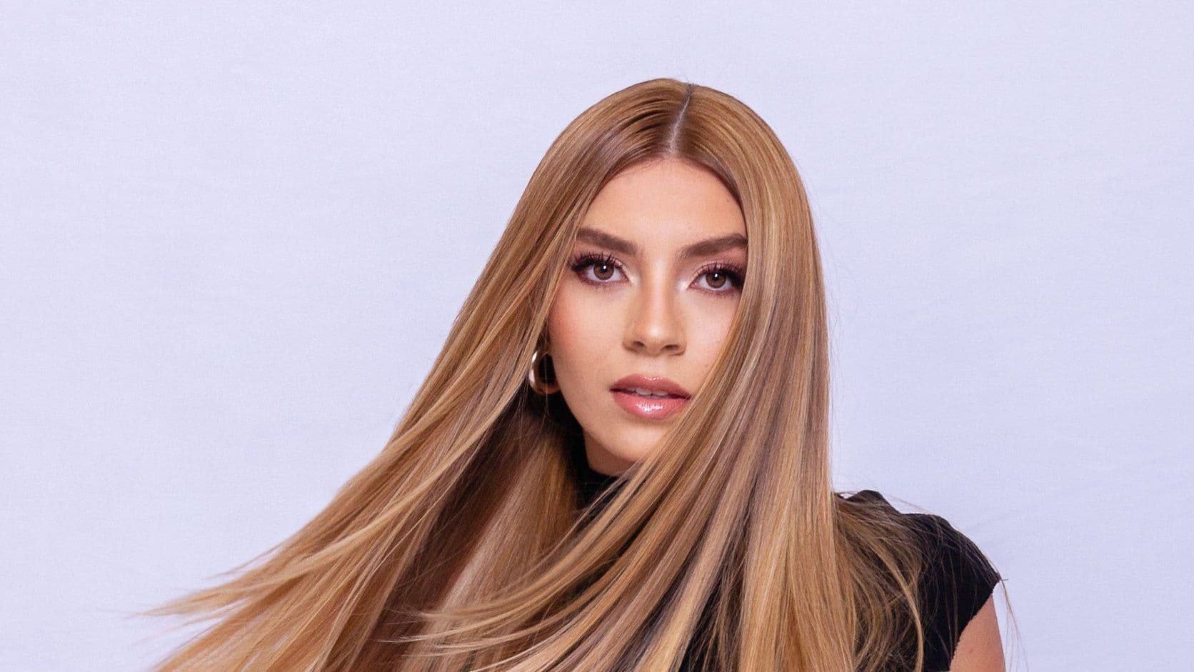 Woman with long straight hair extensions, styled and flowing.